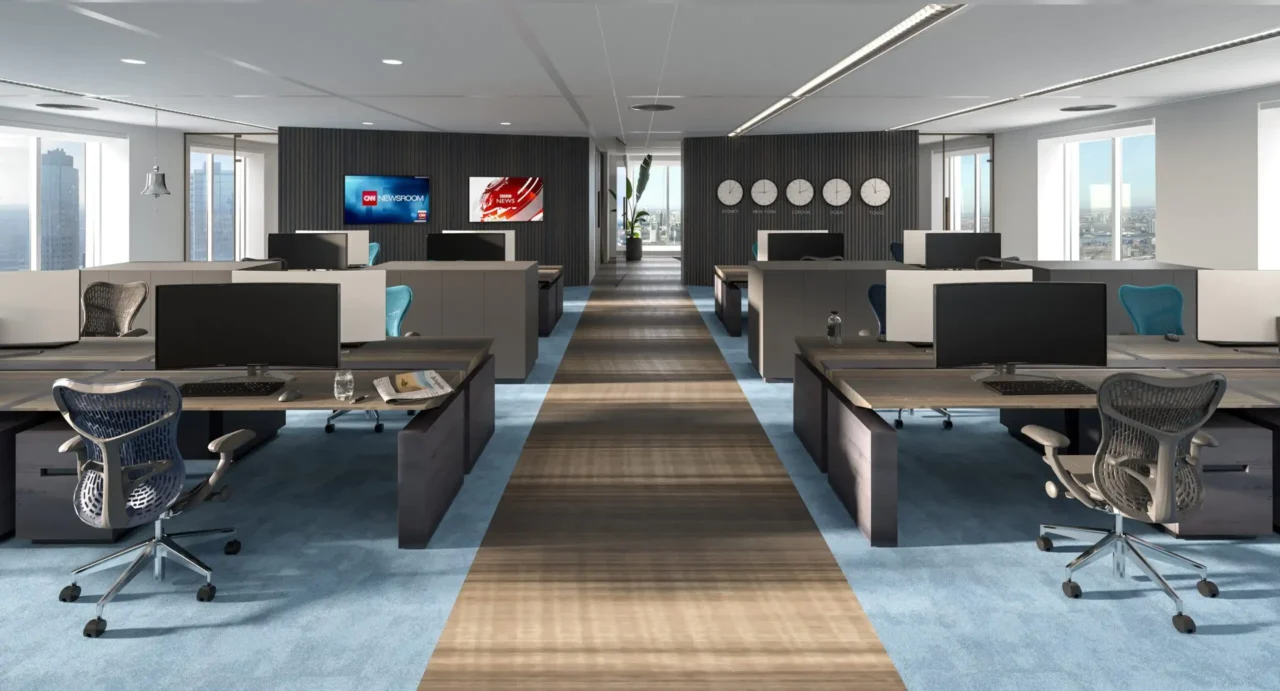 Interieur van een high-end kantoortuin door ERIC KANT met ergonomische bureaustoelen, houten bureaus, een centraal looppad en een wand met wereldklokken en nieuwsschermen.